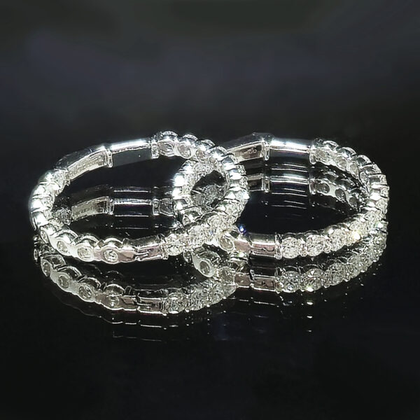 Classic hoop earrings set with dazzling round cut lab-grown diamonds against white gold.