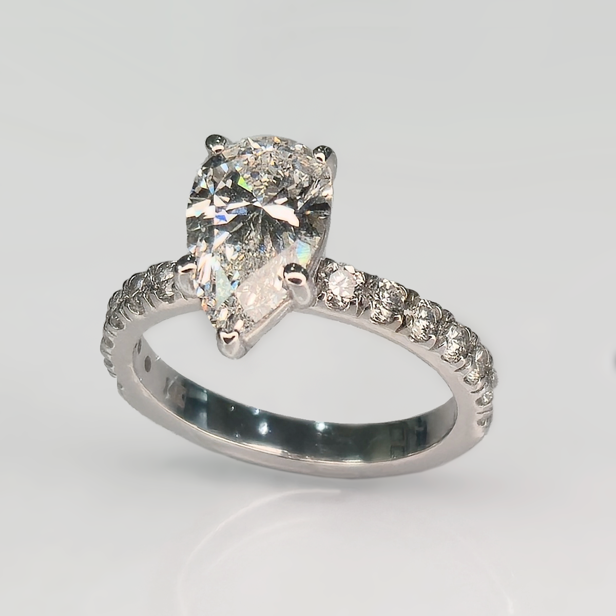 The 2.09 ct center stone creates a bold focal point, while seven round accent diamonds in the band add subtle sparkle that enhances the ring without overwhelming its clean, solitaire-inspired design.