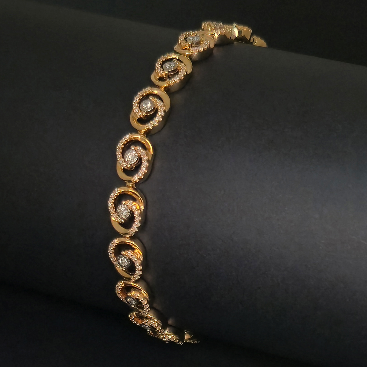 A flowing spiral design that draws the eye outward from a central diamond, creating movement and brilliance with every turn.