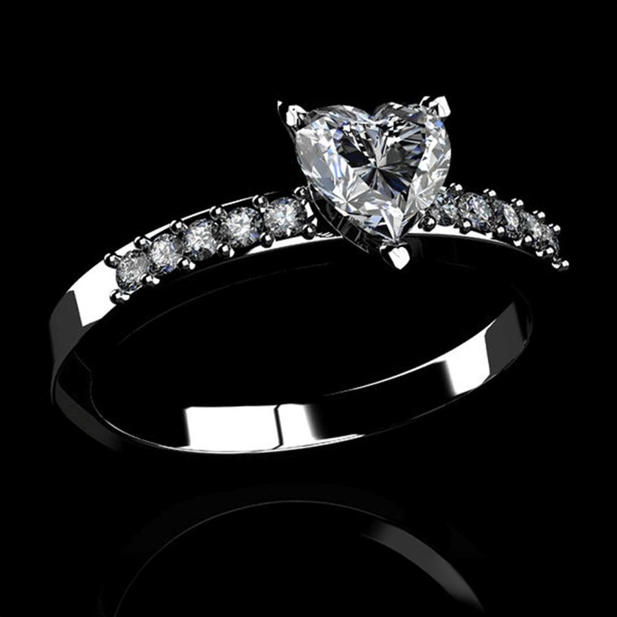 Custom designed diamond engagement ring with a heart shaped center stone and round diamonds on the band. Isolated on a black background.
