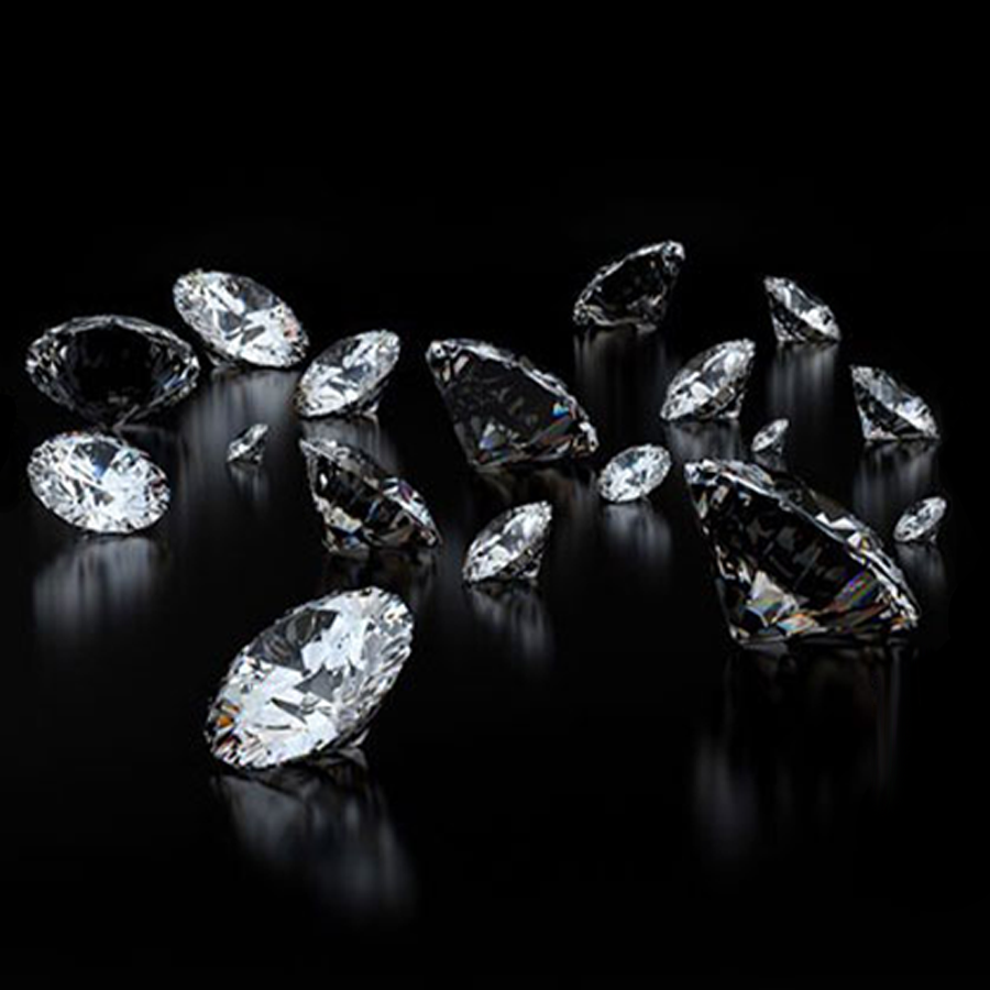 scattered white diamonds on a black background with slight light reflection