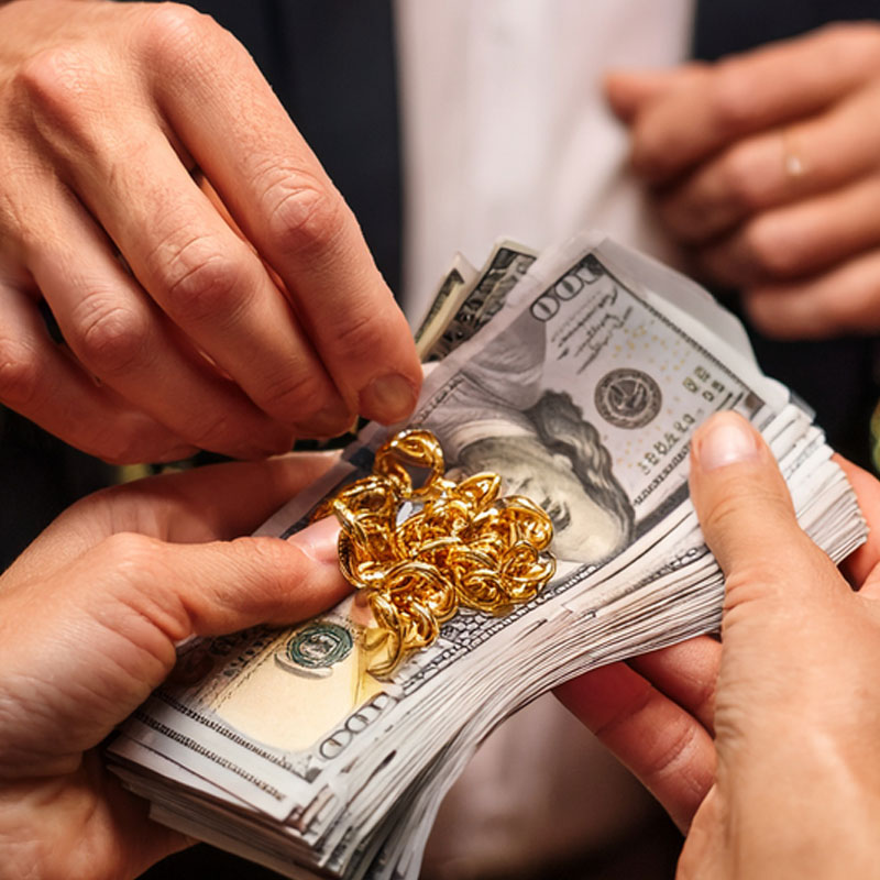 cash for gold. an exchange of two hands getting hundreds of dollars for gold
