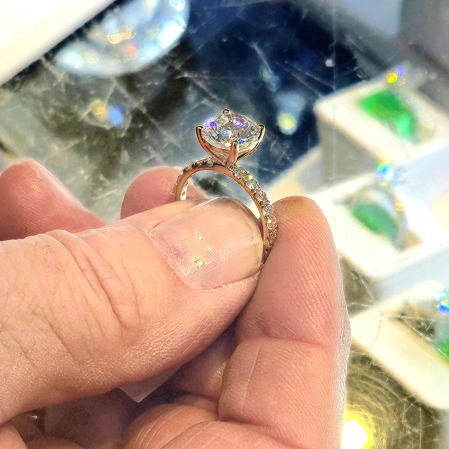 Closeup of a jeweler showing of a lab-grown diamond Solitaire engagement ring