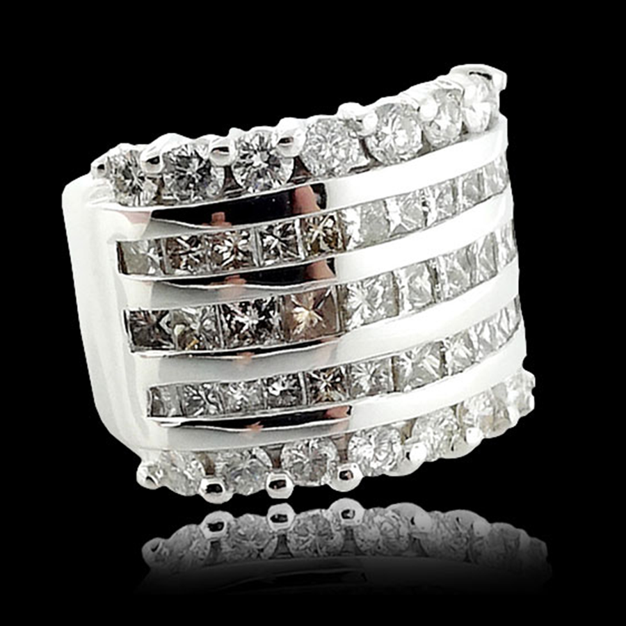 Luxary Rings A luxury diamond ring set in white gold with a five rows of round diamonds. Isolated on a reflective black background.